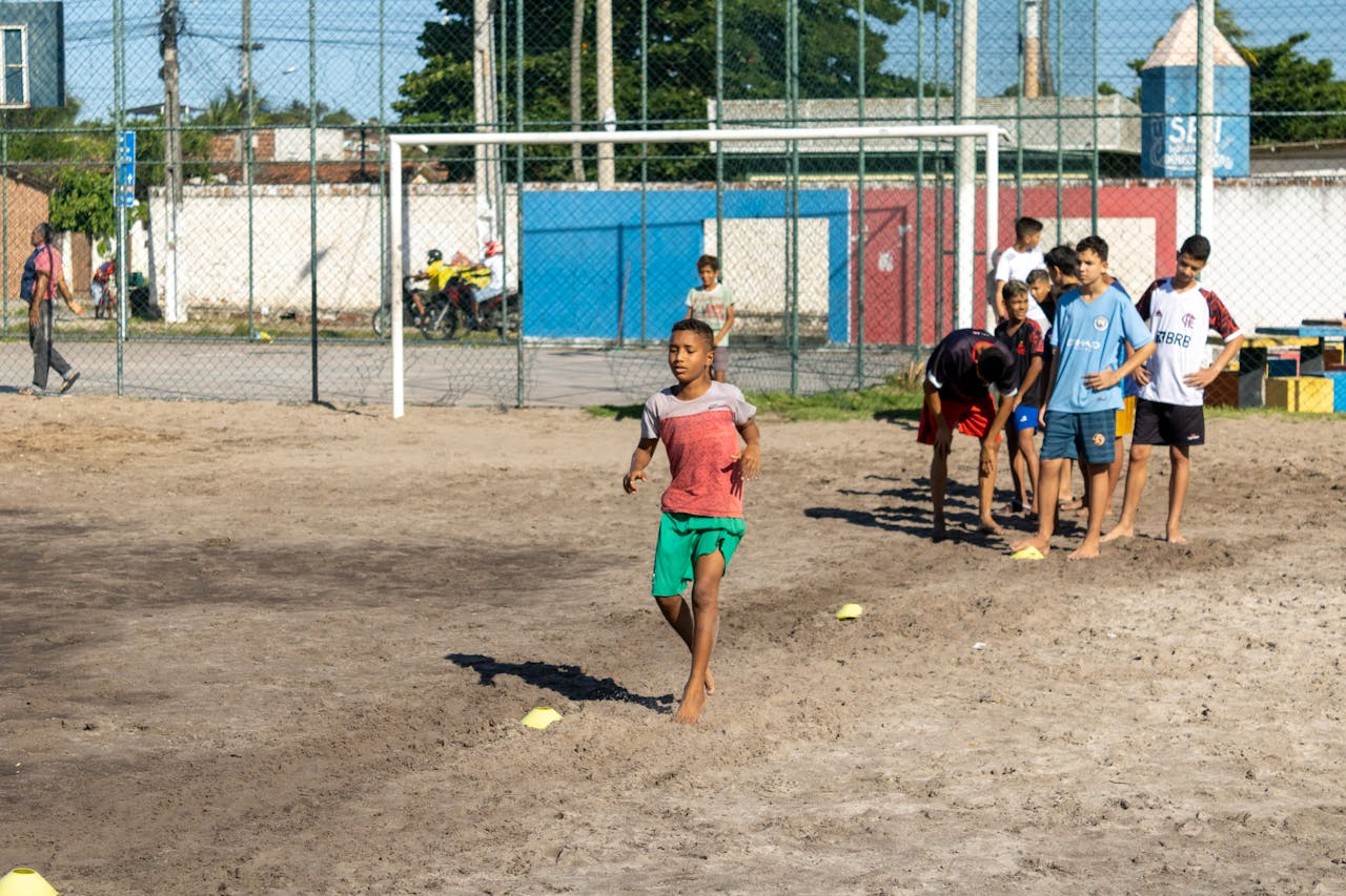 services-img Boys practicing soccer on a sunny day, showcasing teamwork and athletic skills.