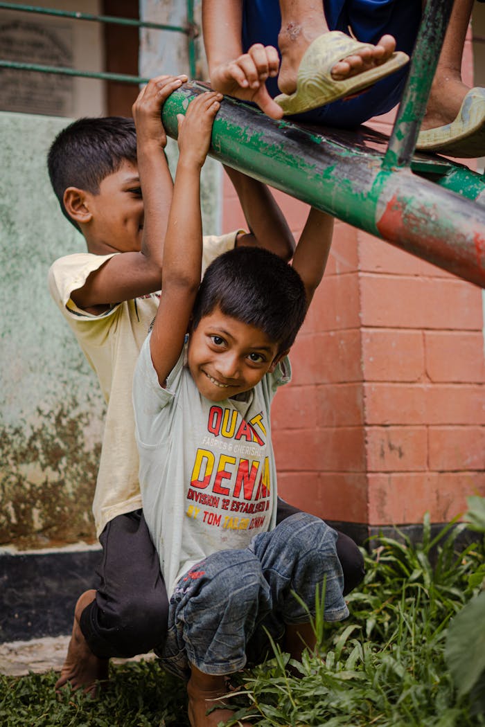 Happy children enjoying playtime on a colorful seesaw outdoors, expressing pure joy and friendship.